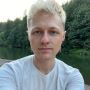 Picture of Patrick Bedard wearing a white shirt with trees in the background.